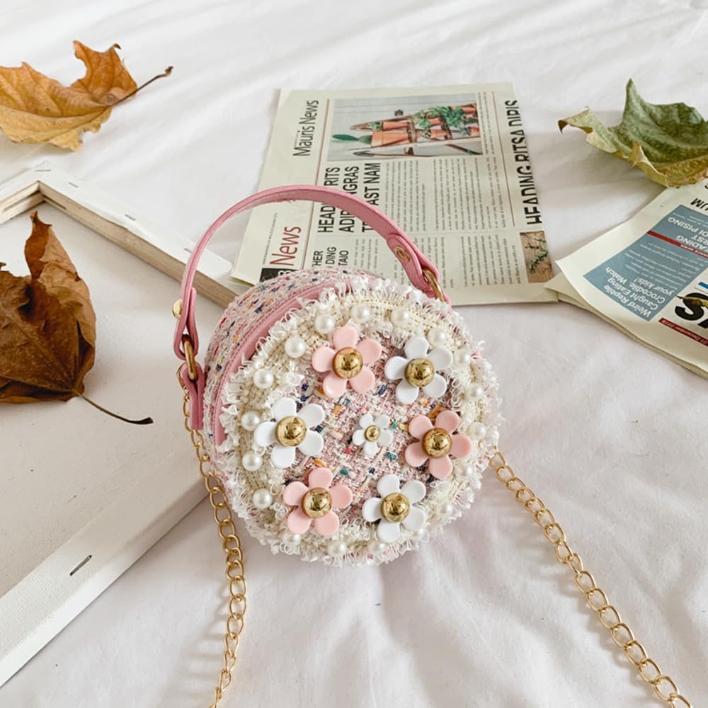 Round handbag with floral decorations on a white surface with newspapers and leaves.
